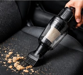 Brush attachment picking up crumbs from a car seat